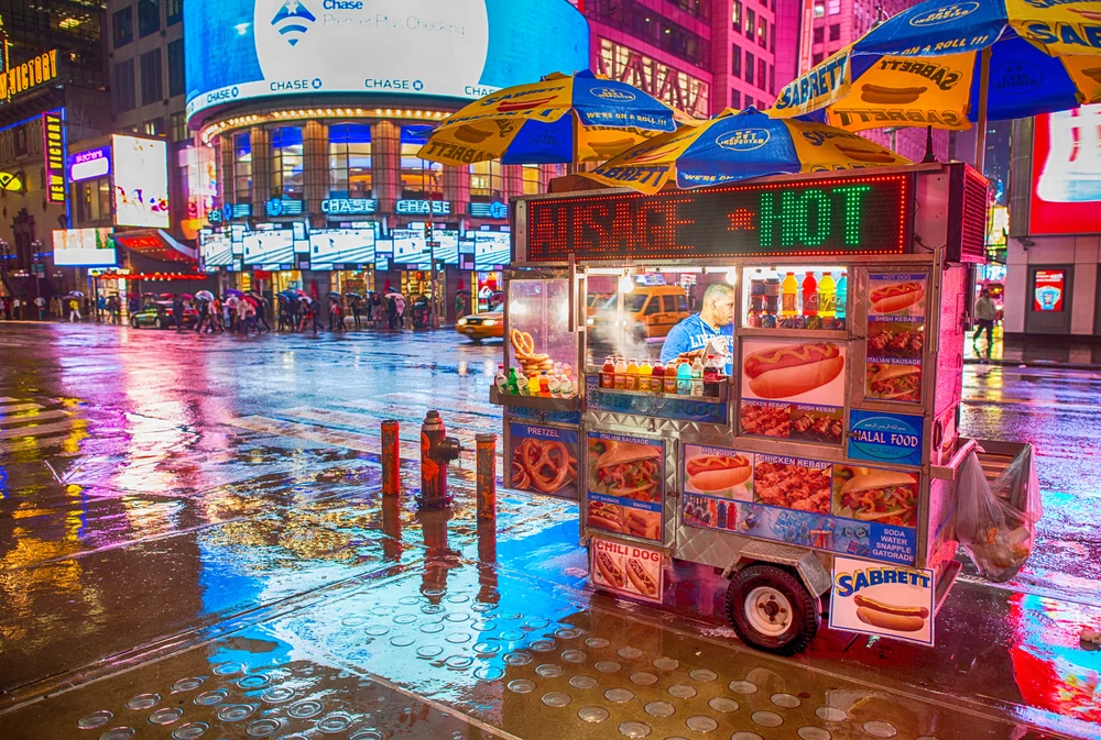 A hot dog cart/food vendor in downtown New York City
