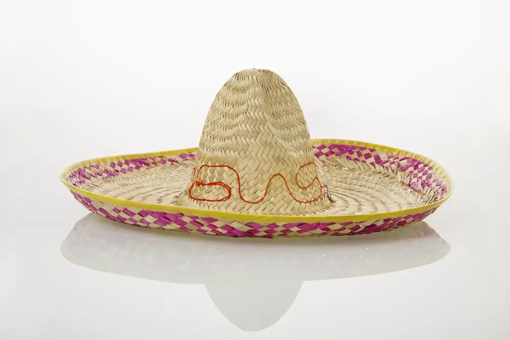 Mexican straw sombrero hat on white background.