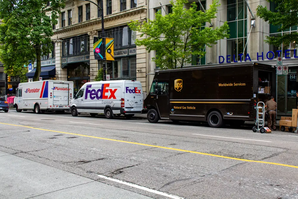 FedEx and UPS trucks parked. These companies pay a lot for parking tickets.